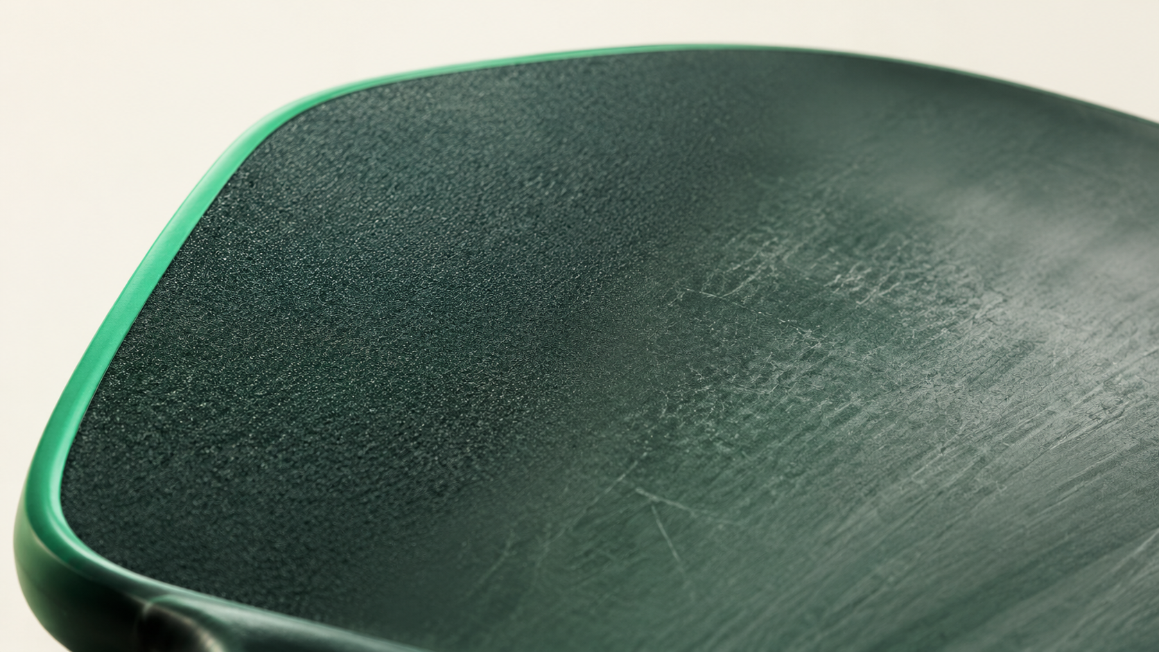 Macro of a worn paddle face showing scuffing and lost surface texture